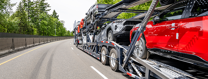 Open trailer hauling multiple vehicles